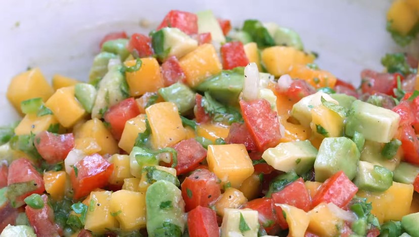 Vibrant diced mango, avocado, and tomato salsa