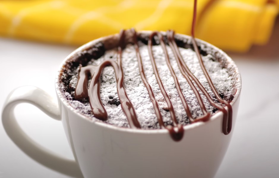 Decadent chocolate mug cake, drizzled with melted chocolate