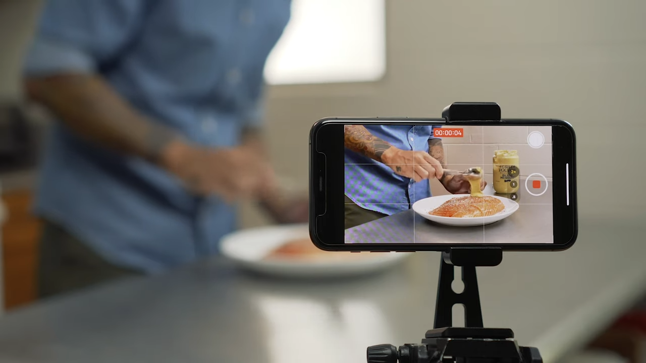 A Person Filming a Cooking Tutorial with A Smartphone
