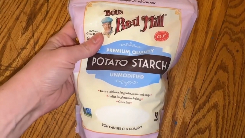 A Person Holding a Package of Bob’s Red Mill Premium Quality Potato Starch
