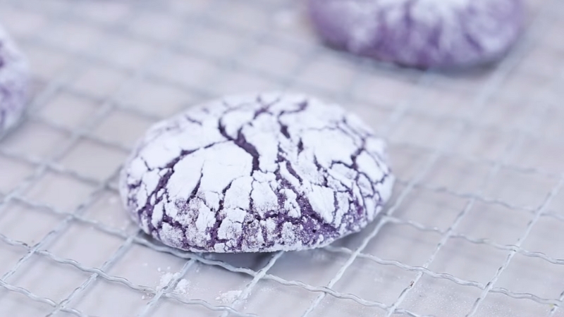 A Freshly Baked Ube Crinkle Cookie Sits on A Cooling Rack