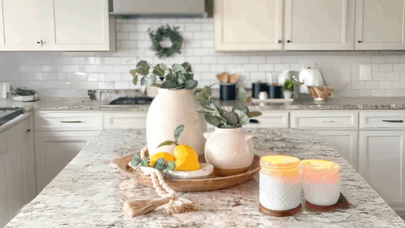 Modern kitchen island with vases, lemons, and candles