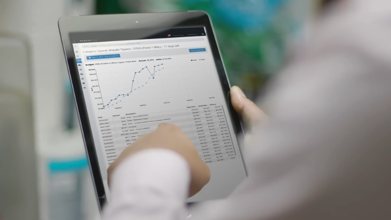 Using MarginEdge restaurant management software to analyze spending and food costs on a tablet