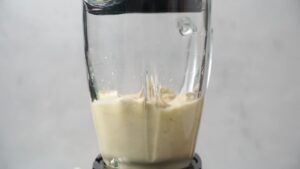 Cashew sauce blending in a clear glass blender