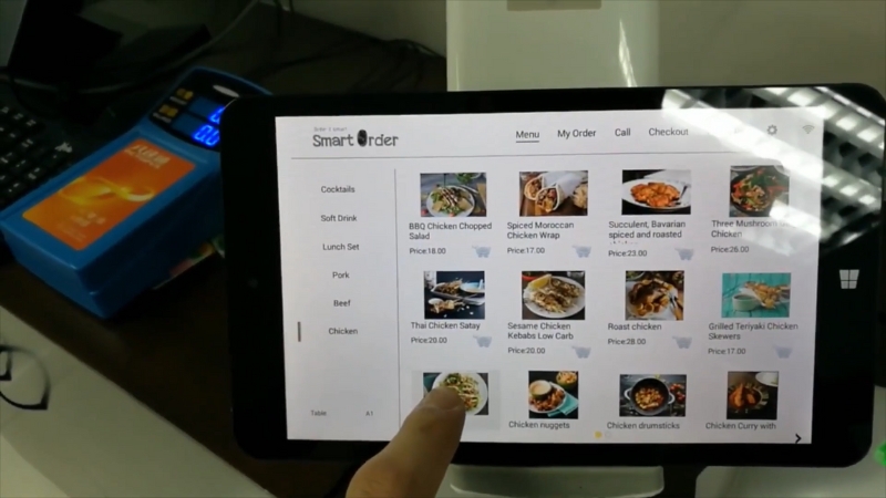 Restaurant POS menu on a tablet with someone selecting an item