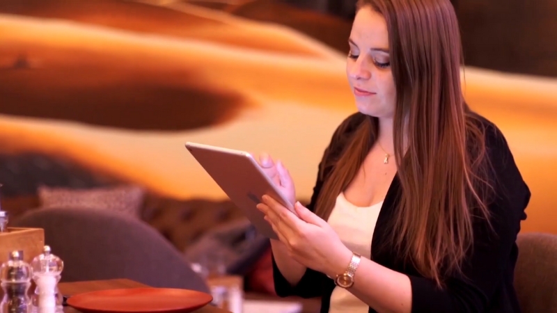 Restaurant staff using a tablet to manage operations