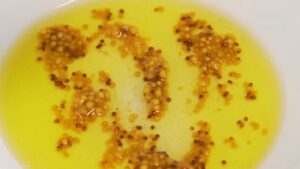 Mustard and oil dressing for pickled herring salad in a bowl