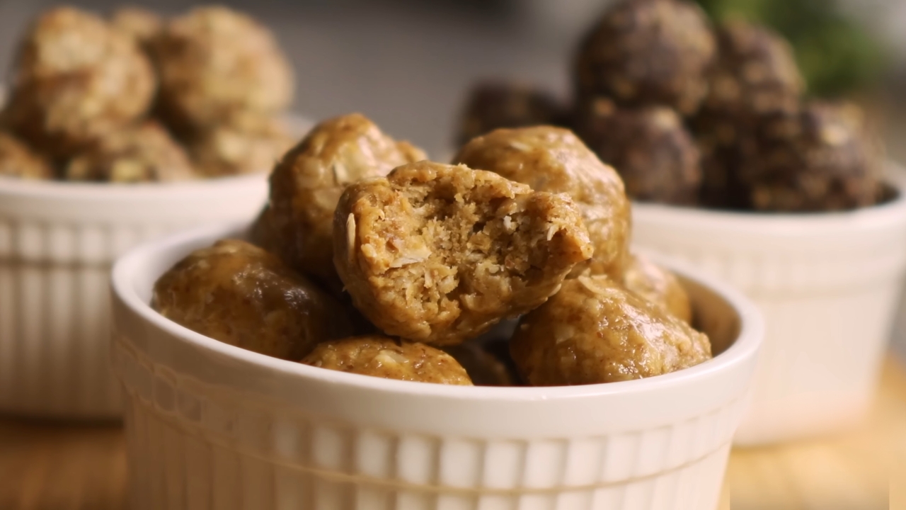 A bowl of no-bake energy balls made with dates, walnuts, and oats